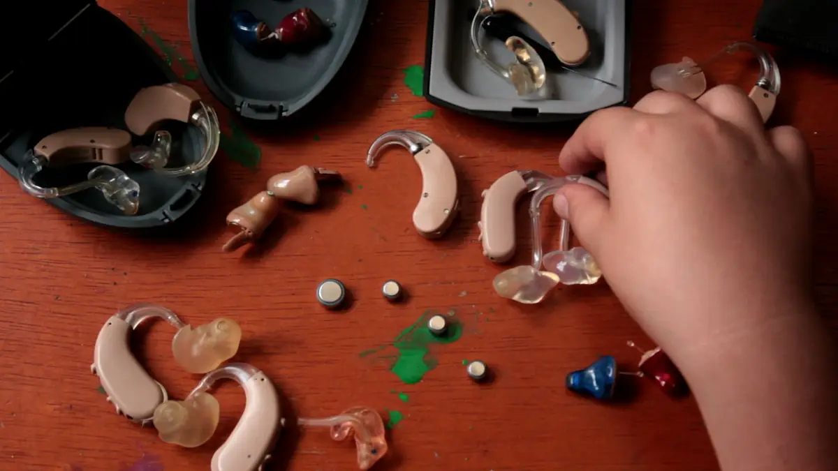 Assorted modern hearing aids displayed together in a clinic